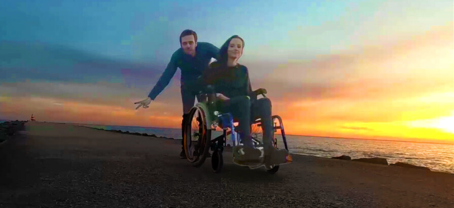 couple wheelchair beach sunset